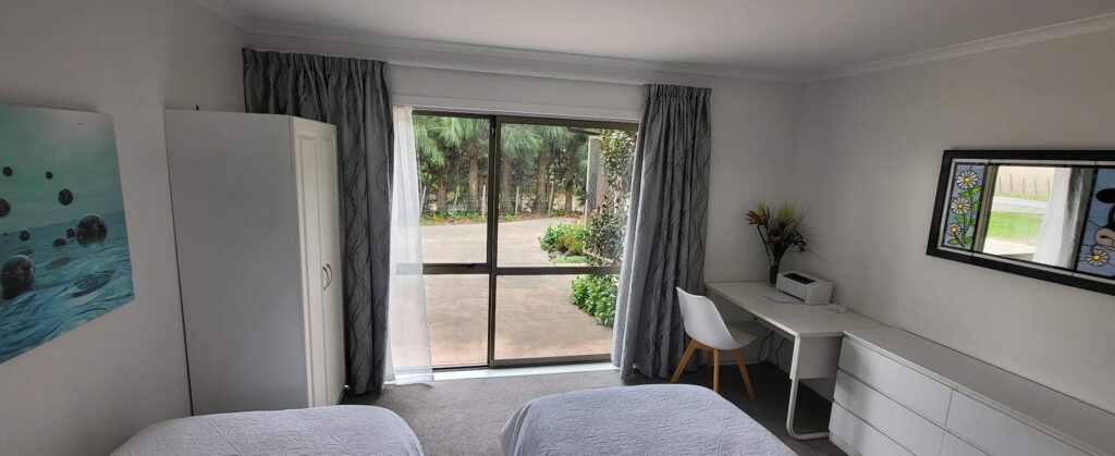Cottage bedroom with desk and garden outlook