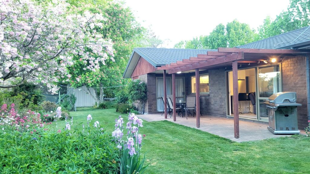 The cottage patio framed by blossom and irises