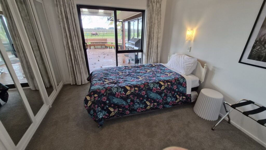 Farmhouse bedroom with doors opening to the deck