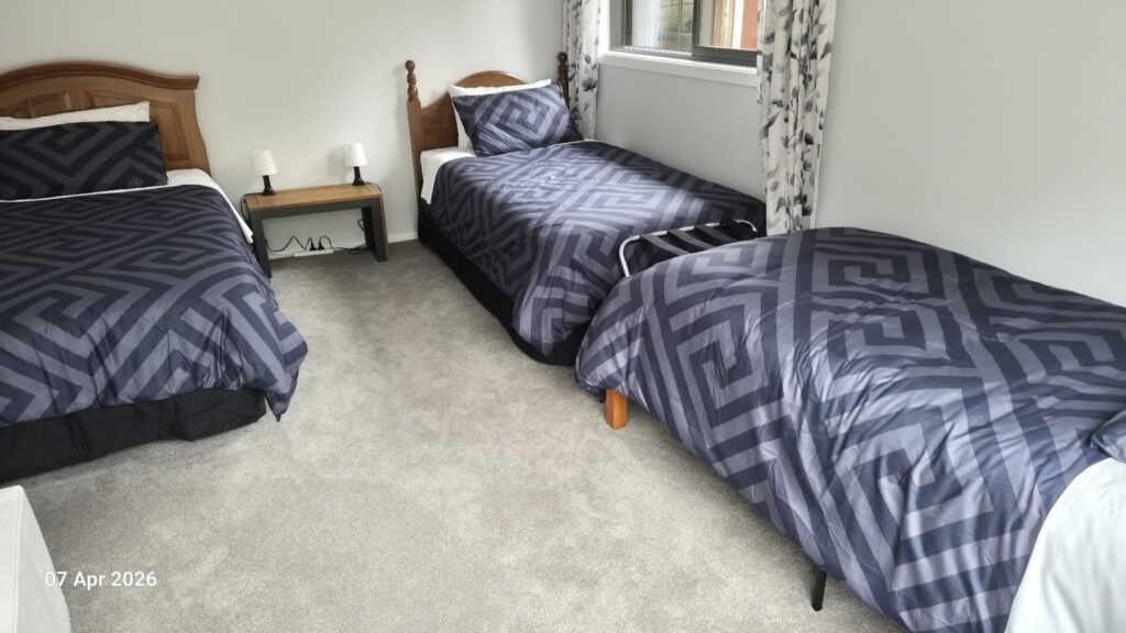 Farmhouse bedroom with three single beds