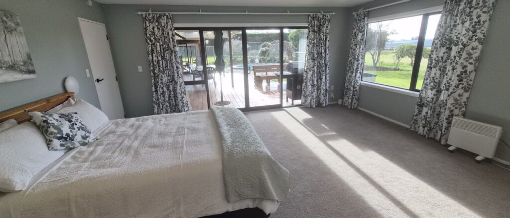 Bedroom looking out to the deck and garden