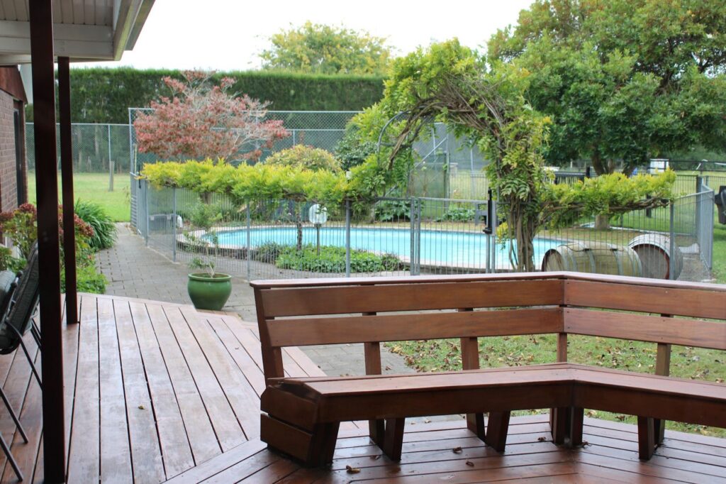 Built-in deck seating beside the fenced pool