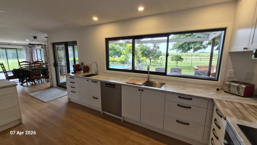 Farmhouse kitchen with a long window over the paddocks