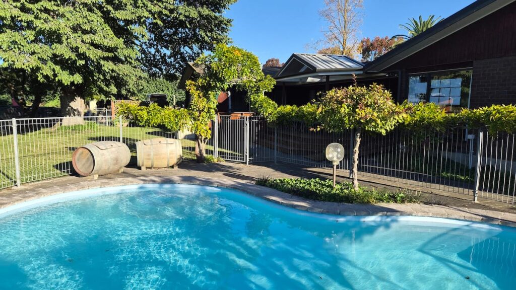 The fenced pool beside the house